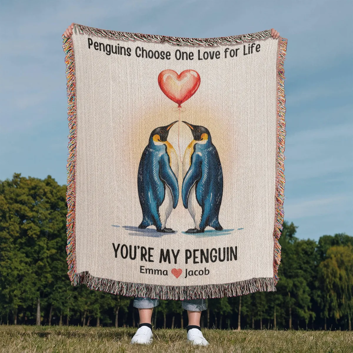 Personalized penguin keepsake blanket held outdoors